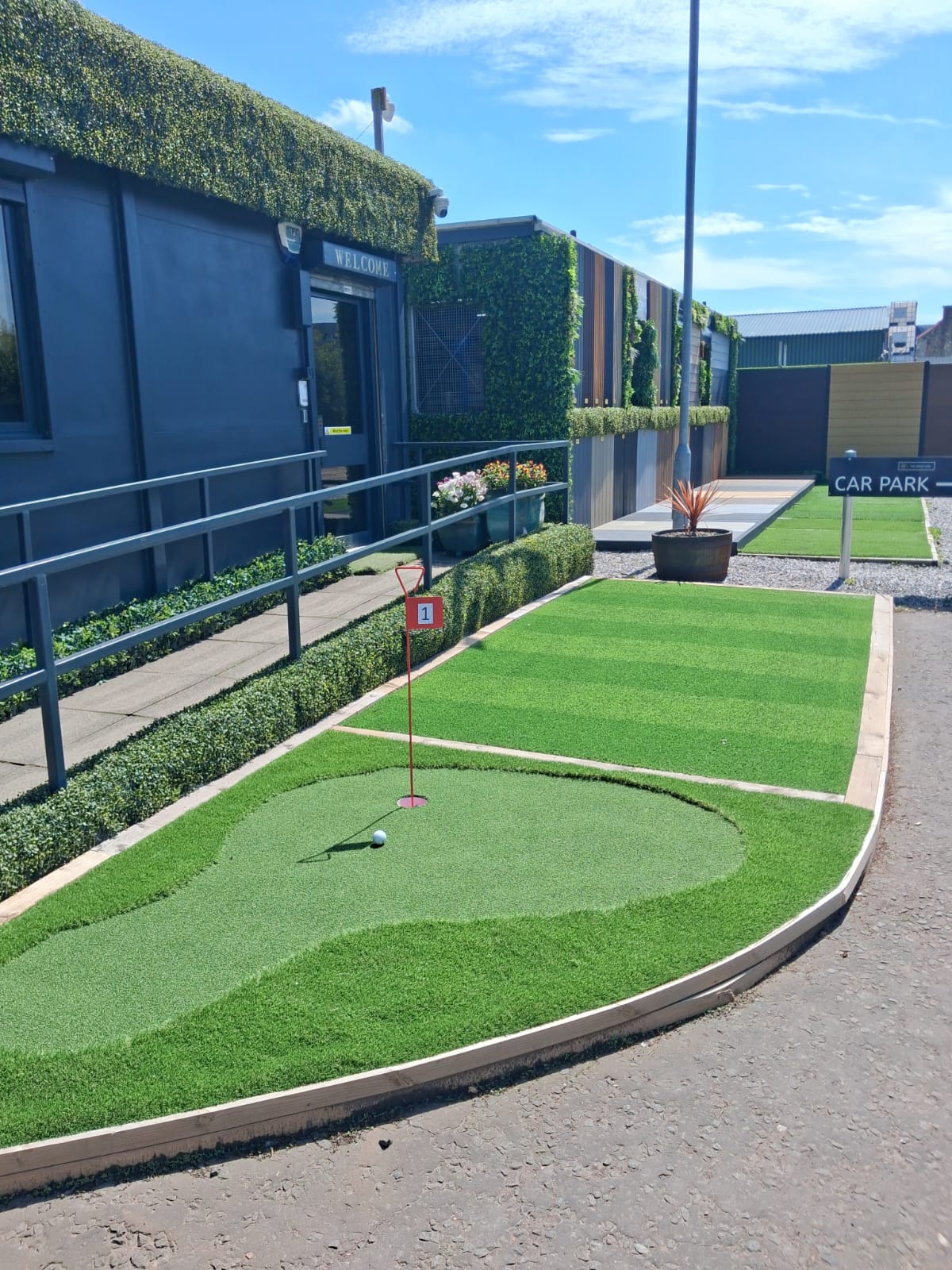 2ft metal putting flag and cup on artificial grass.