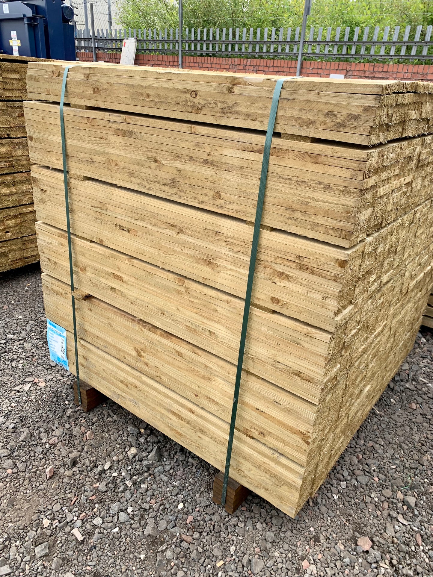 A pack of 4ft treated wooden fence slats in The Grass Yard.