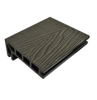 A grooved composite decking step and edge board in a grey color.