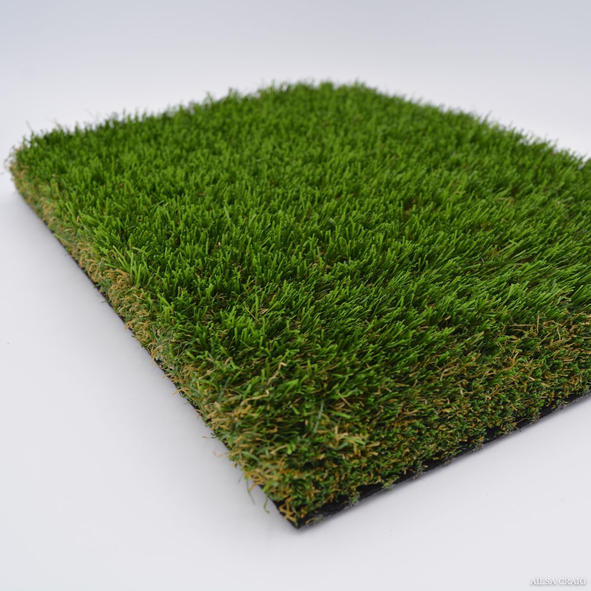 Square artificial grass sample on a white background