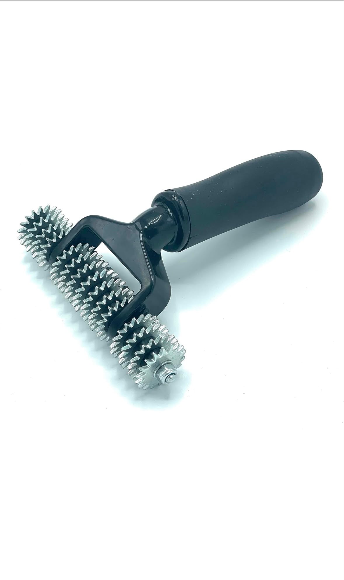 A black double-sided artificial grass roller tool with metal bristles on a white background.