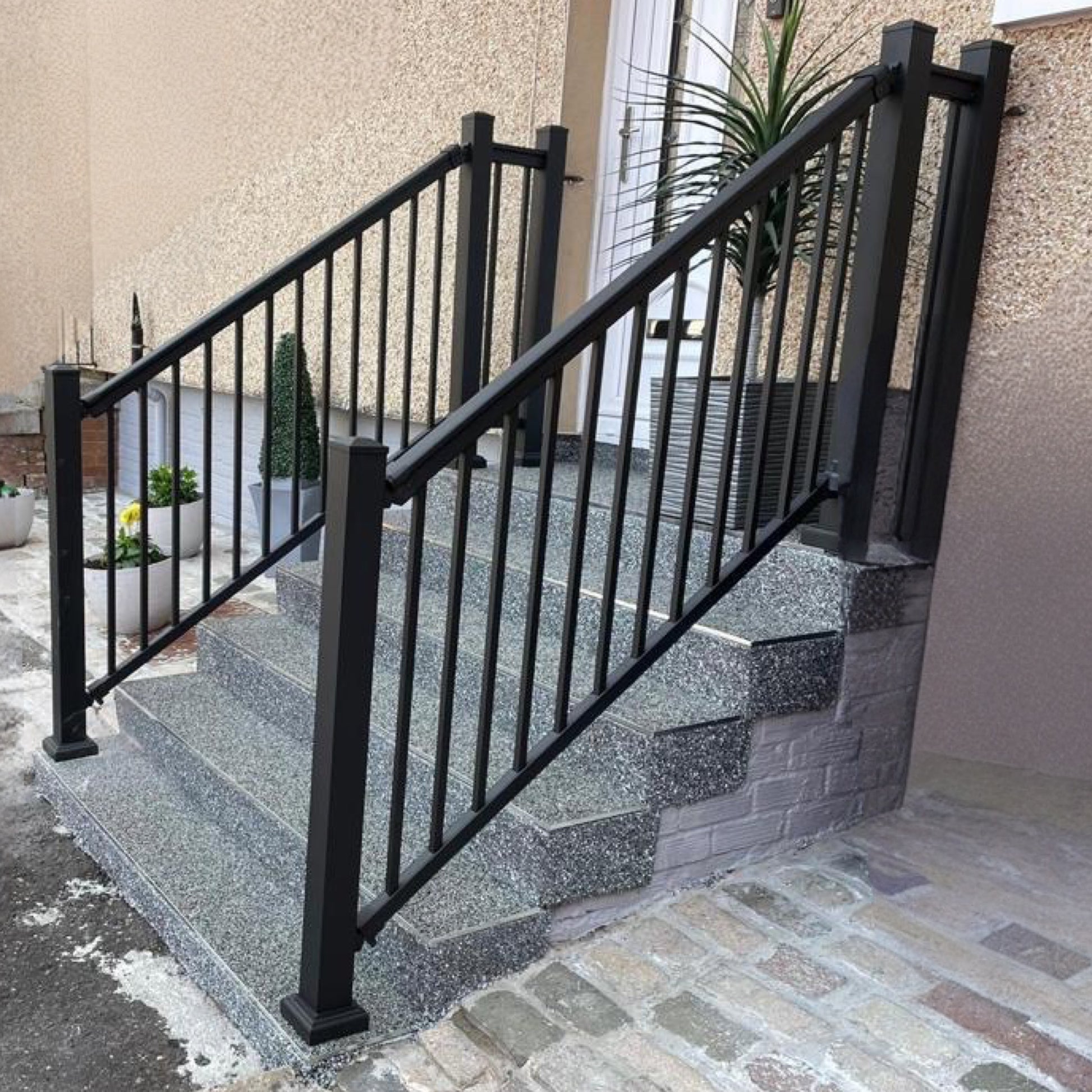 Back Aluminium handrail kit installed on a set of steps.