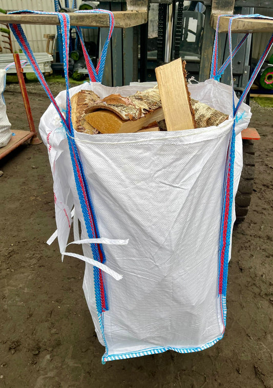 A forklift holding up a full white barrow bag of silver birch firewood logs in The Grass Yard Paisley.