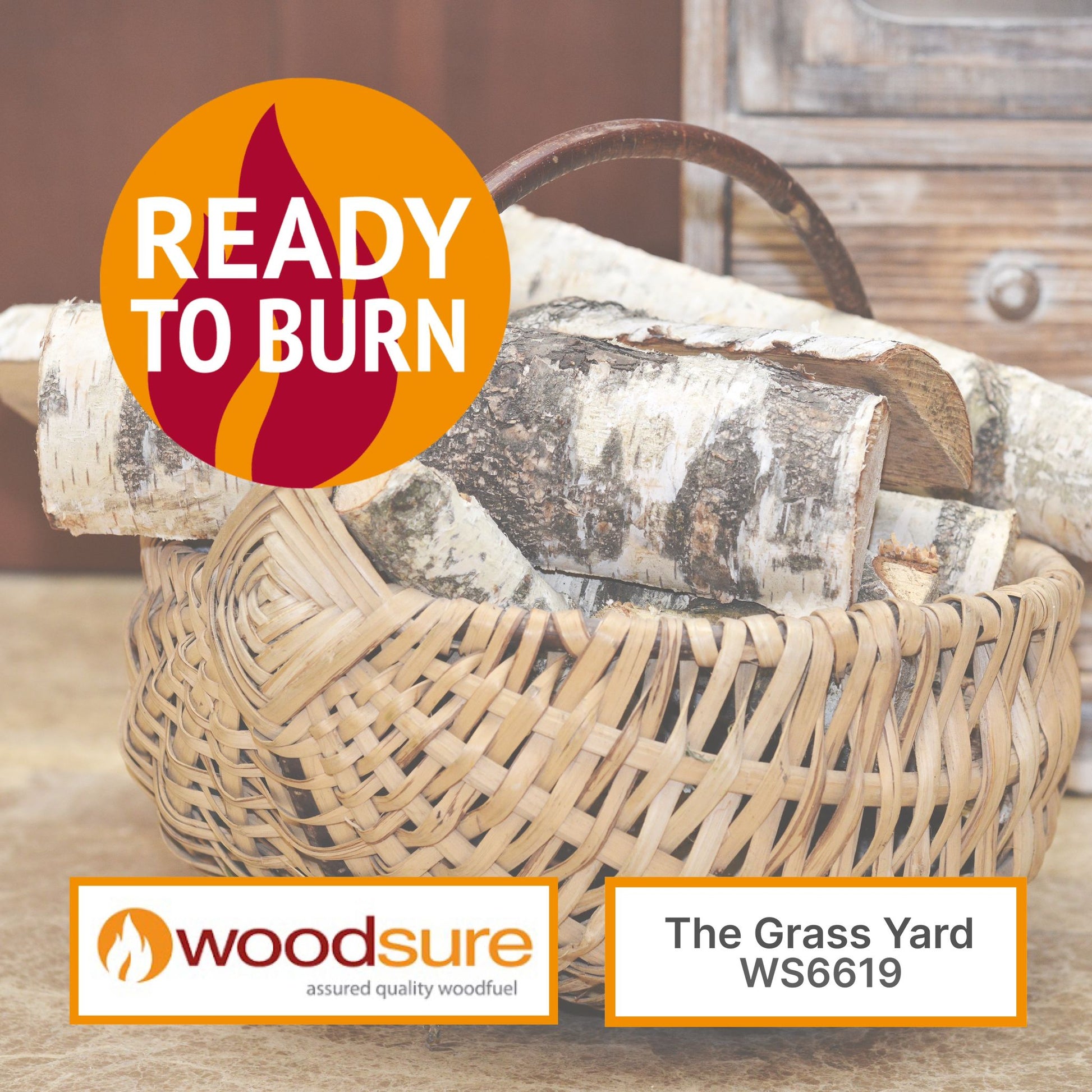 Birch firewood in a wicker log basket.