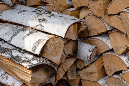 A small neat stack of Birch firewood logs.