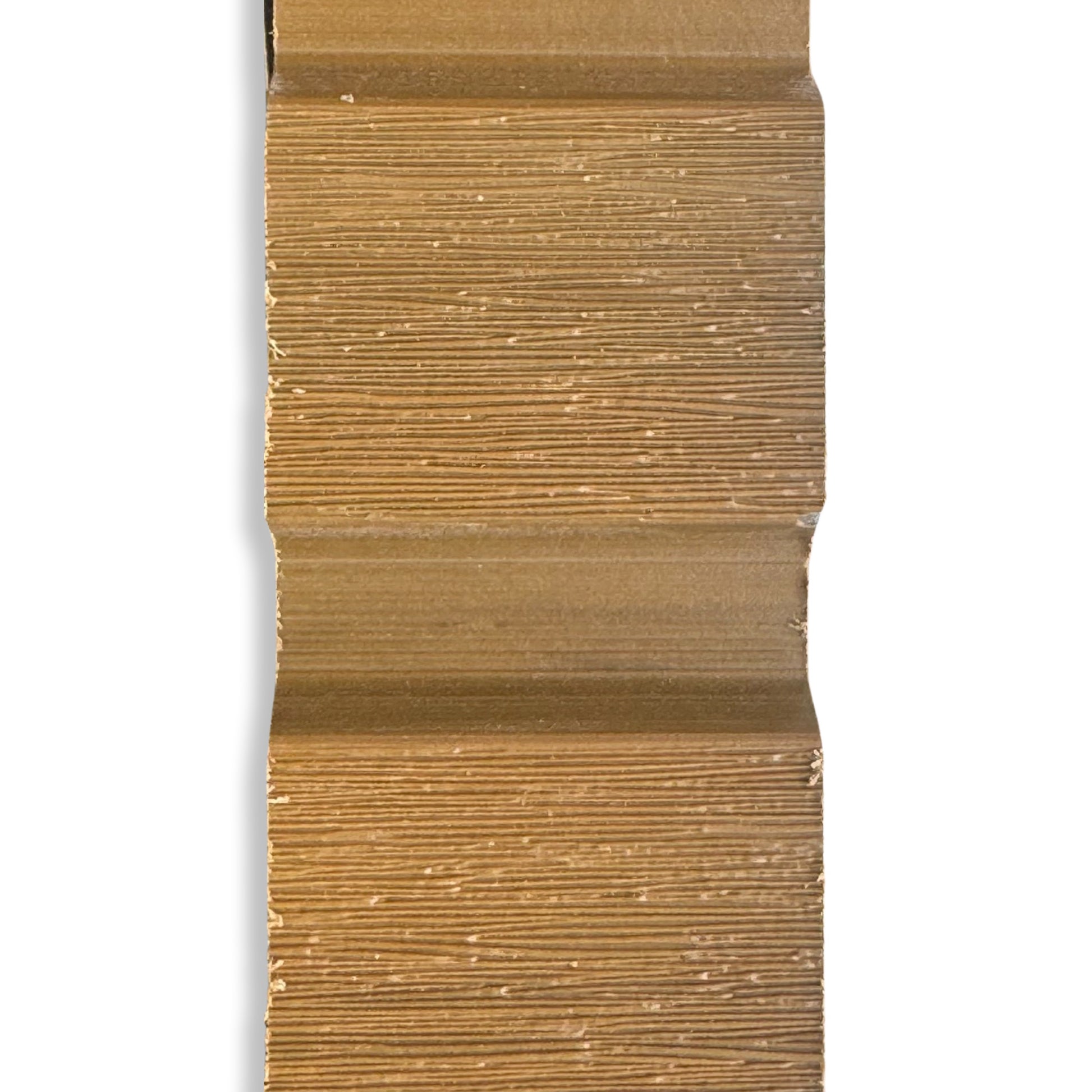 A sample size of cedar composite slatted fencing, close up showing the grain on the board. 