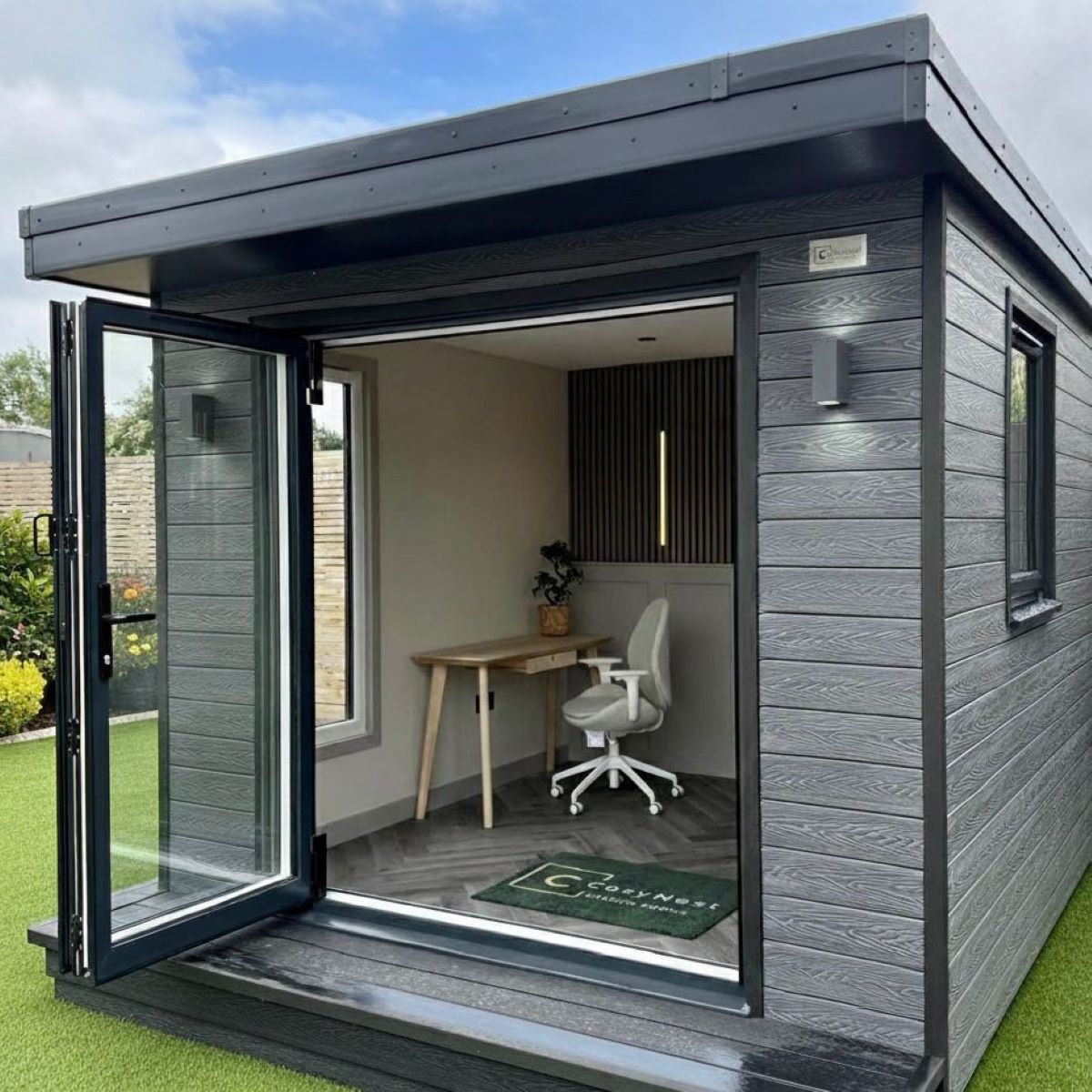 A garden room with grey composite shiplap cladding.