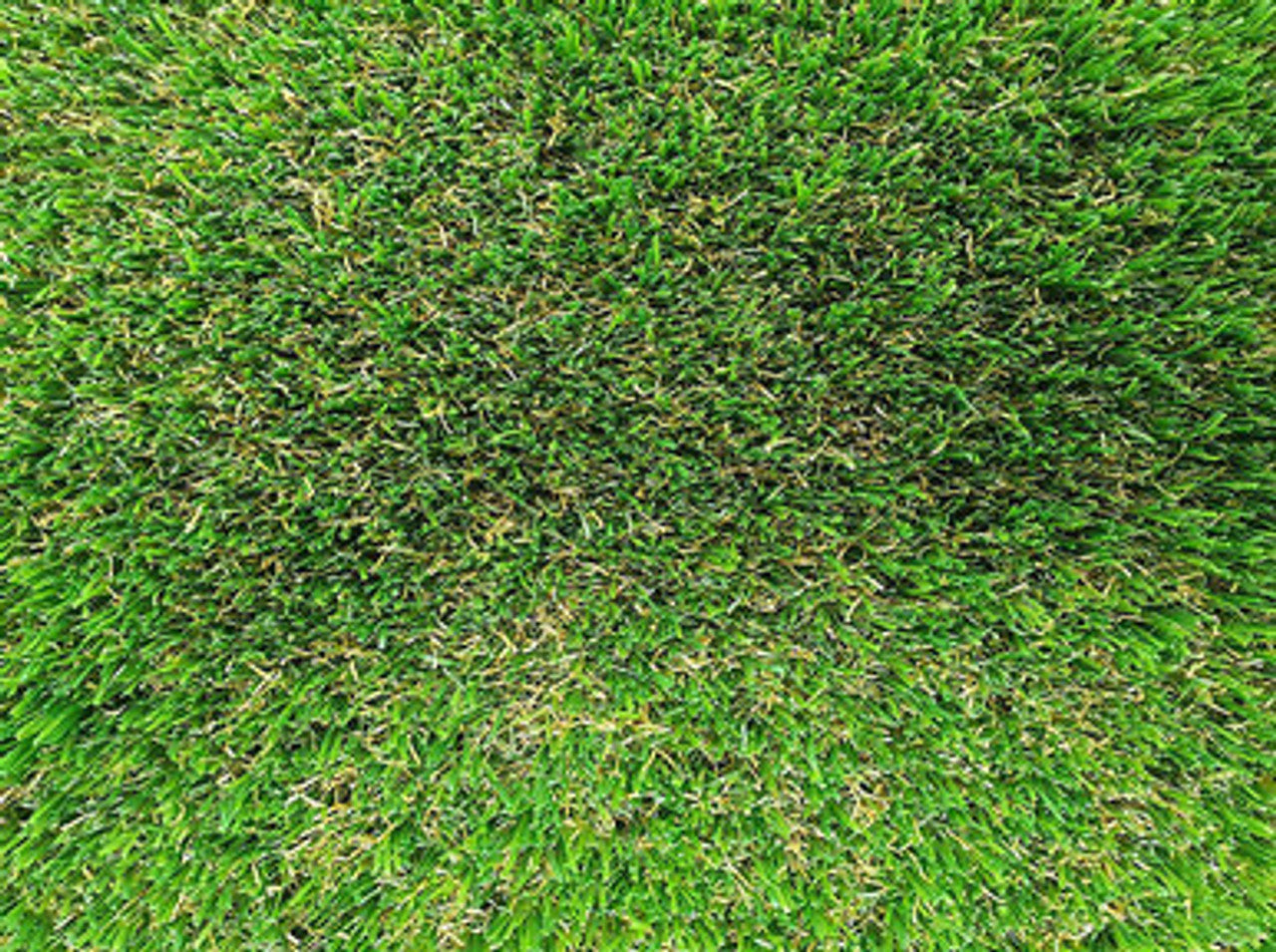 Looking downwards into the pile of endurance 30mm artificial grass showing the green and brown fake grass blades.