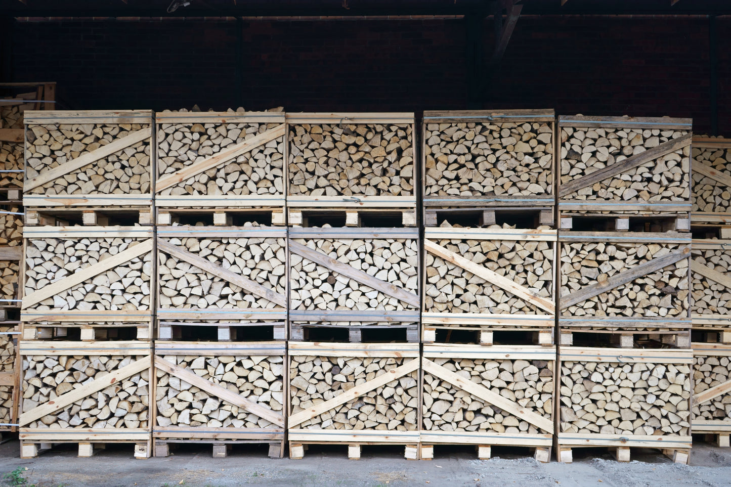 Lots of small sized firewood log crates stacked up ready for delivery.