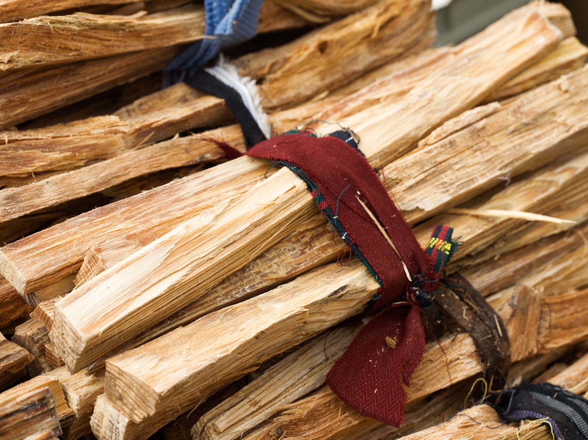 Firewood kindling neatly wrapped with a ribbon for display.