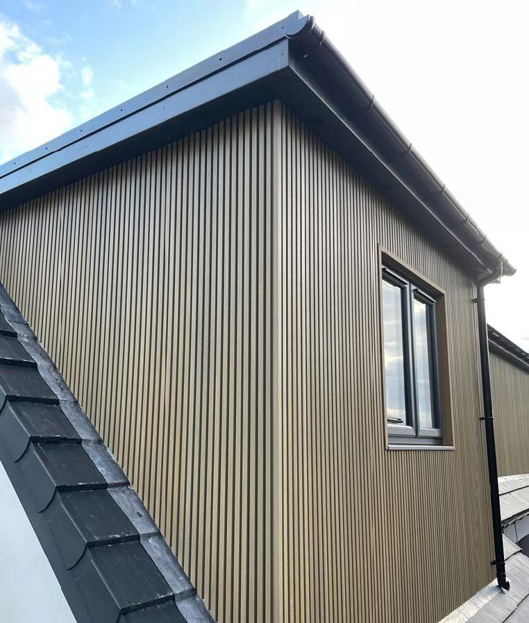 Modern dormer with oak slatted cladding and black roof