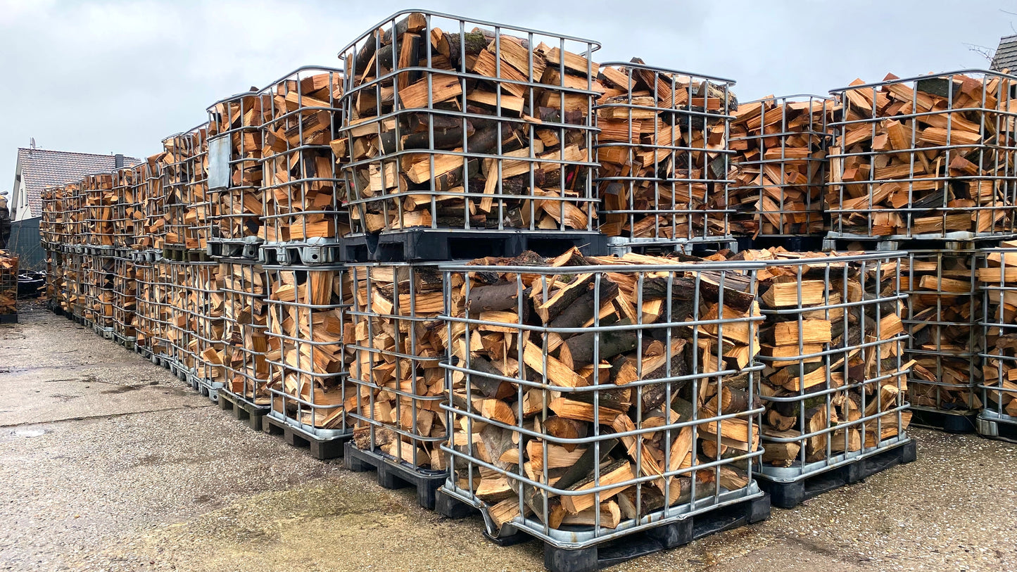 A large number of oak firewood crates stacked up.