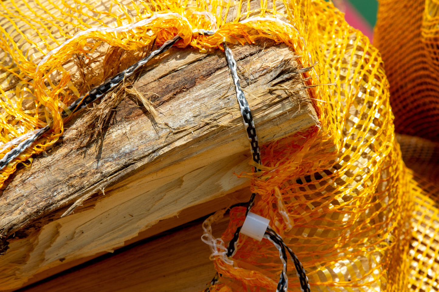 An open orange oak firewood net from he Grass Yard Paisley.