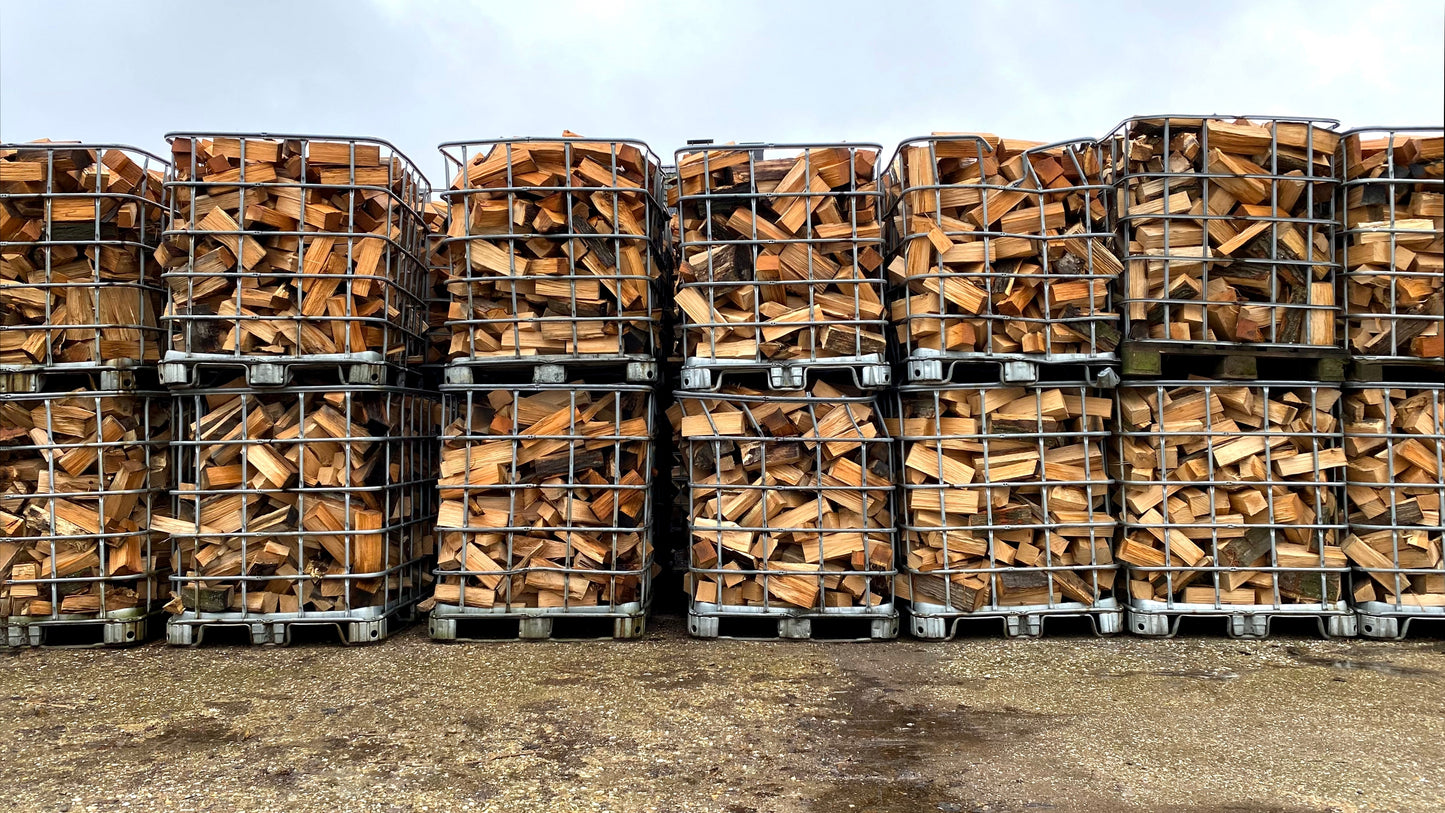 Several IBC tanks stacked with oak firewood.