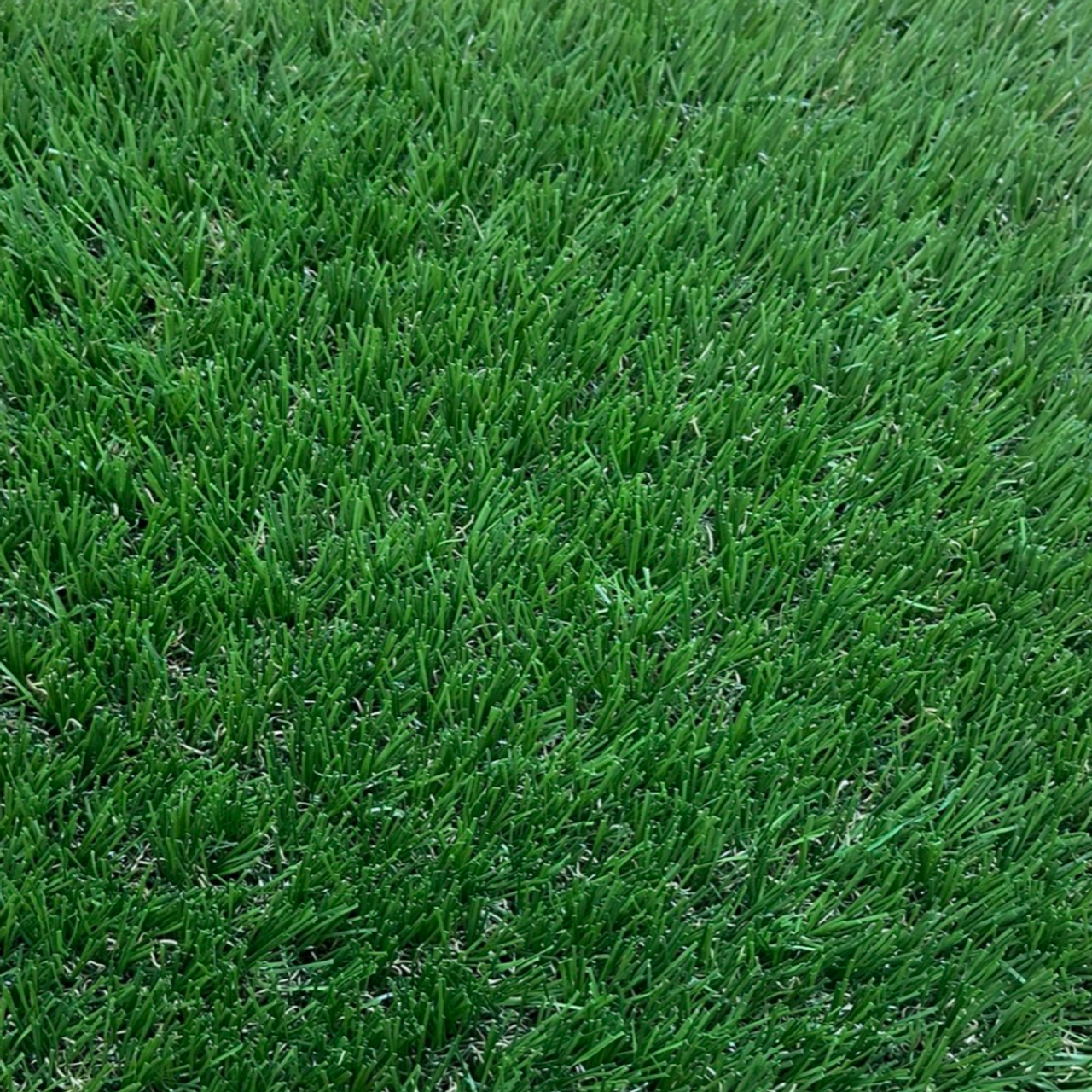 A close up picture of Scalloway dog or K9 fake grass showing the deep dark green artificial grass blades.