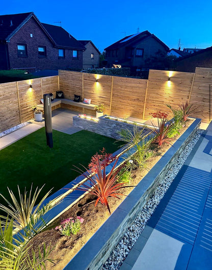 Wooden Venetian slat fencing installed in a newly landscaped back garden in Glasgow also showing, porcelain and artificial grass.