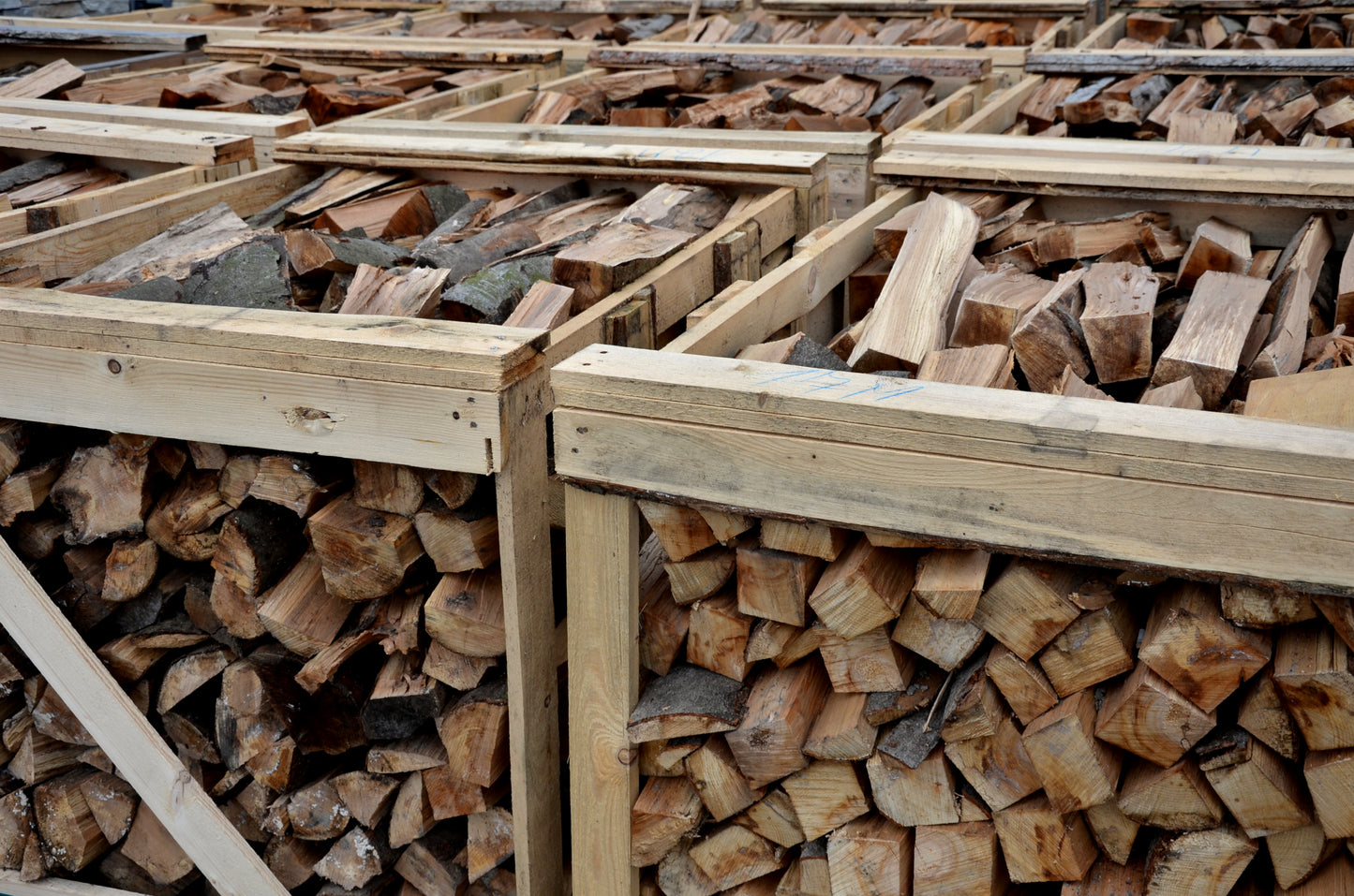 A number of oak firewood crates sat side by side in The Grass Yard.