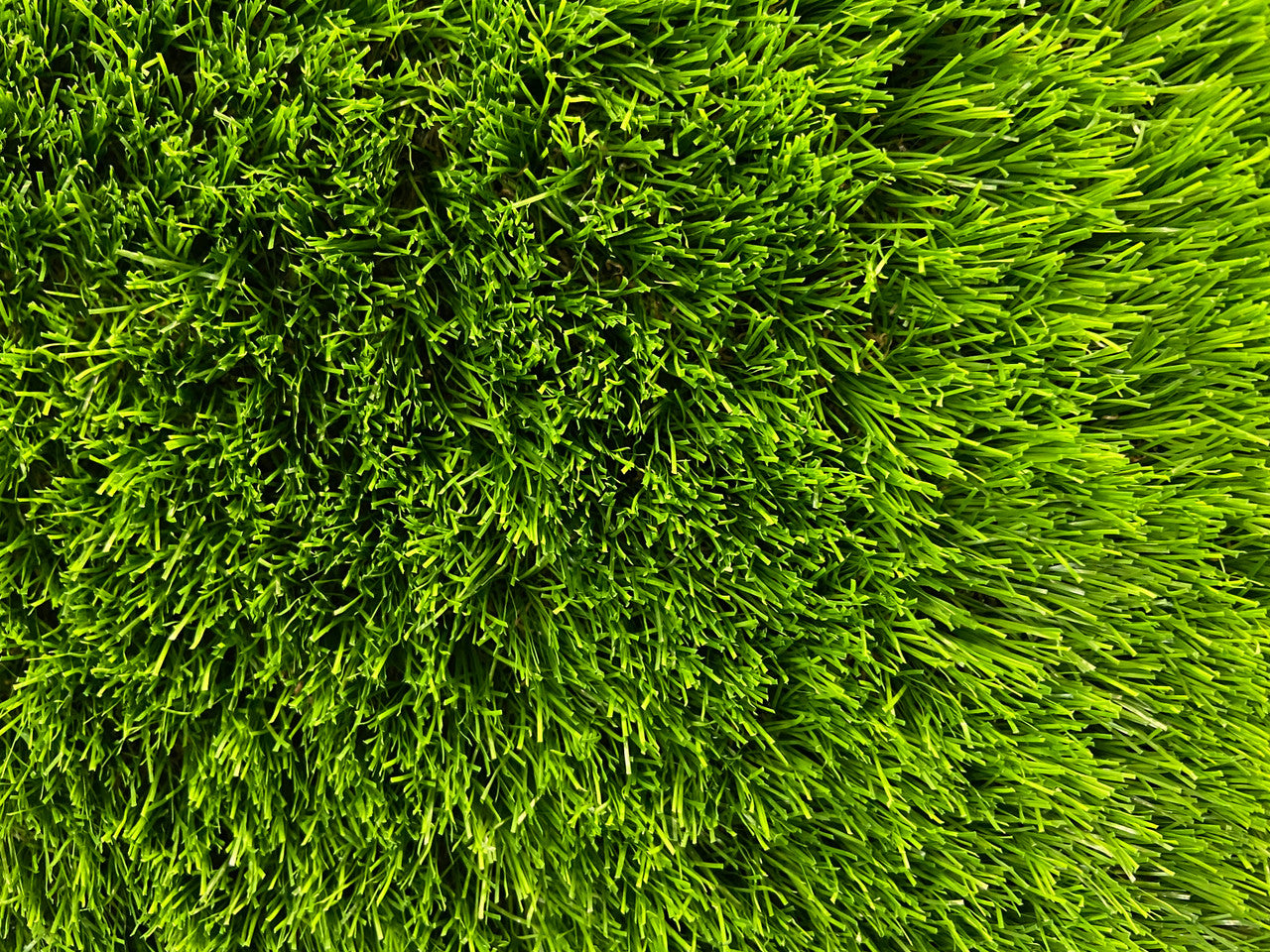 An up close shot of St Kilda artificial grass highlighting the vibrant green colours in the 37mm synthetic grass blades.