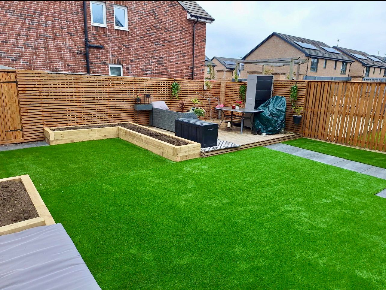 A back garden setting showing St Kilda artificial grass newly installed.