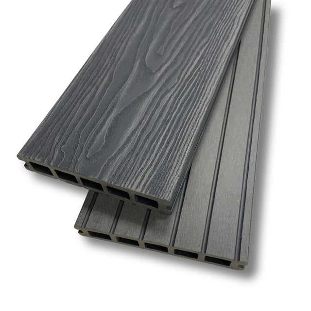 A picture of steel grey composite decking showing the end profile and wood grain.