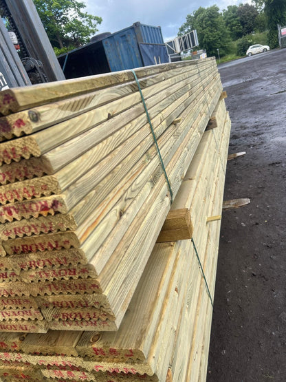 A side profile shot of treated timber decking boards.