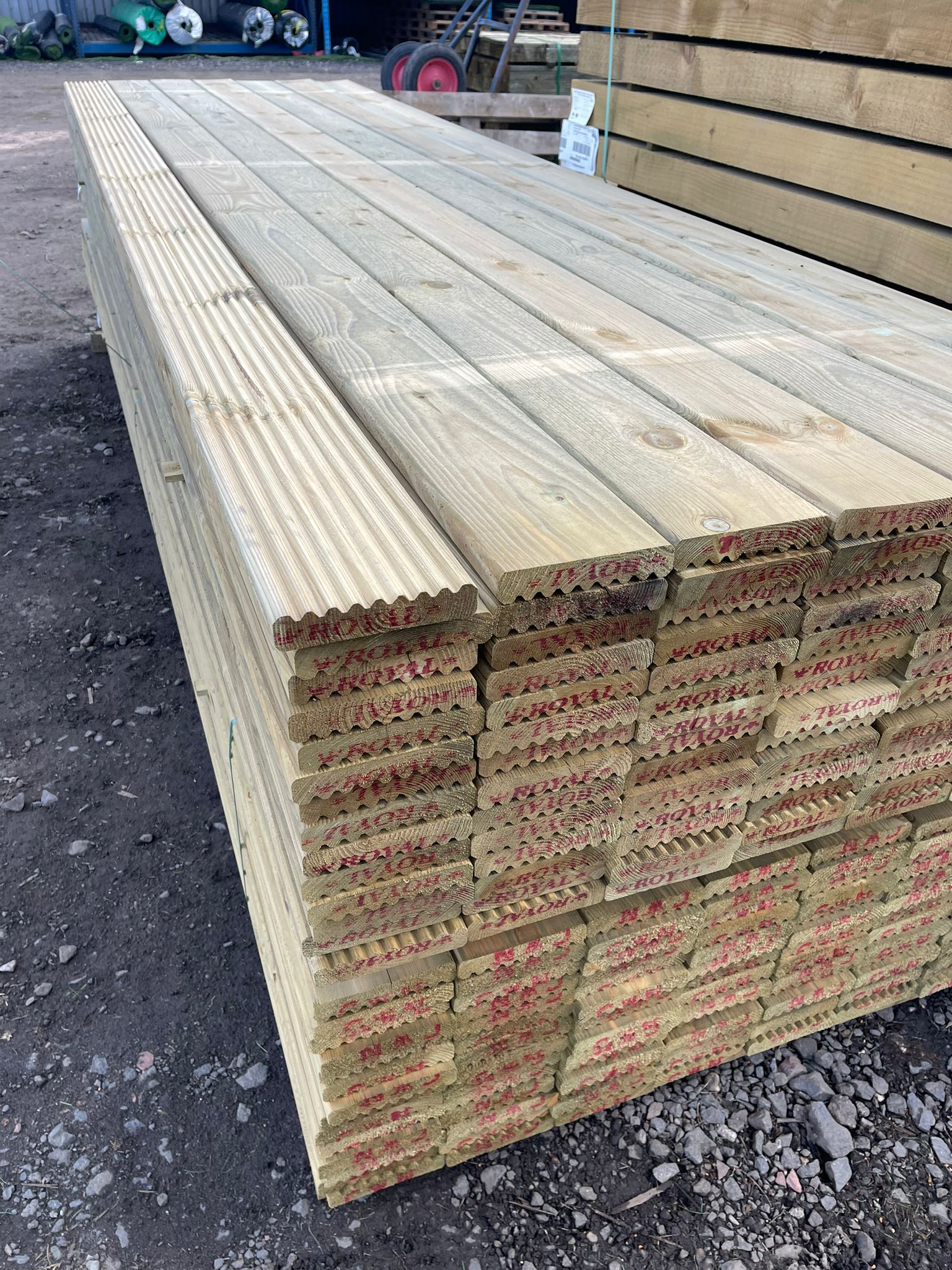 A pack of wooden decking boards in The Grass Yard Paisley.