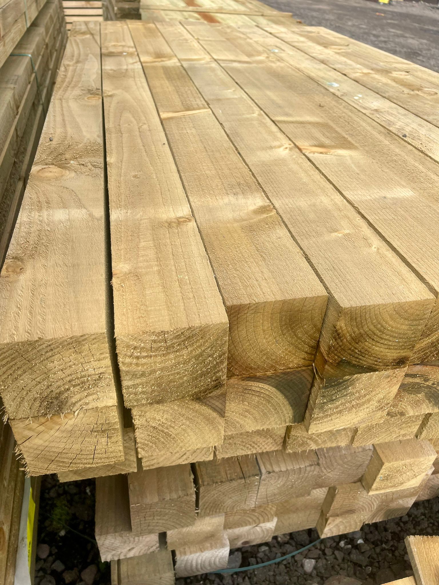 A pack of 8ft treated wooden fence posts in The Grass Yard.