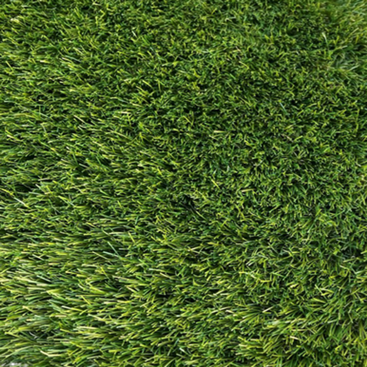 A deep lush artificial grass pictured from above showing the density of the lawn blades.